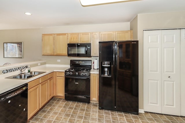 kitchen featuring sink, light brown cabinetry, and black appliances