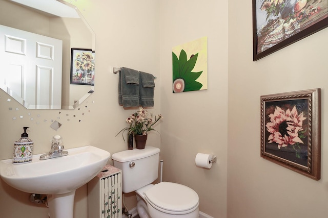 bathroom featuring sink and toilet