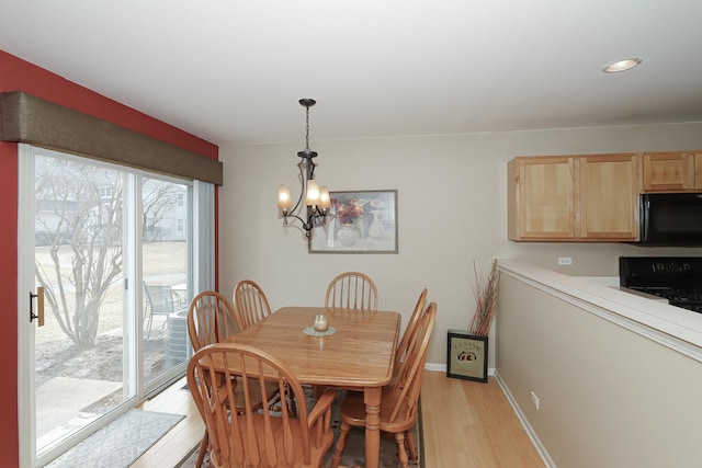 dining area with a notable chandelier and light wood-type flooring