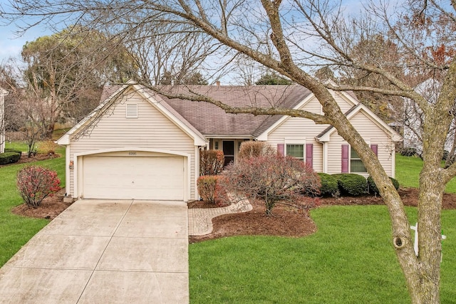 ranch-style home with a garage and a front lawn