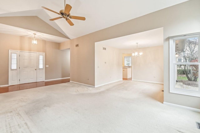 interior space with light carpet, ceiling fan with notable chandelier, and high vaulted ceiling