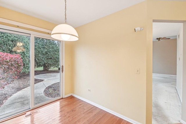 unfurnished dining area with hardwood / wood-style flooring