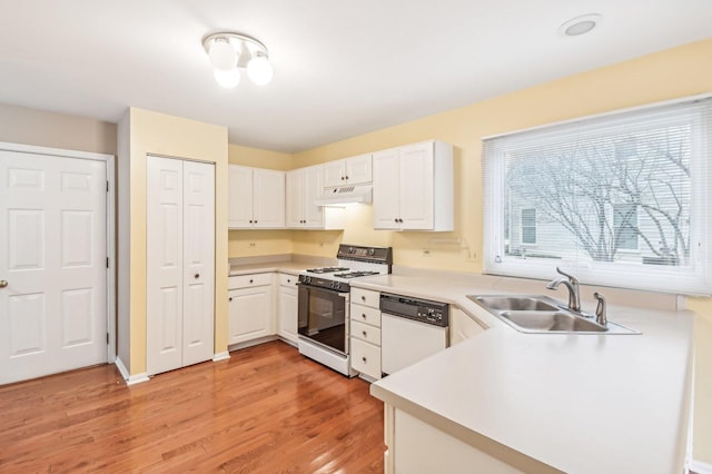 kitchen with white appliances, light hardwood / wood-style floors, sink, and white cabinets