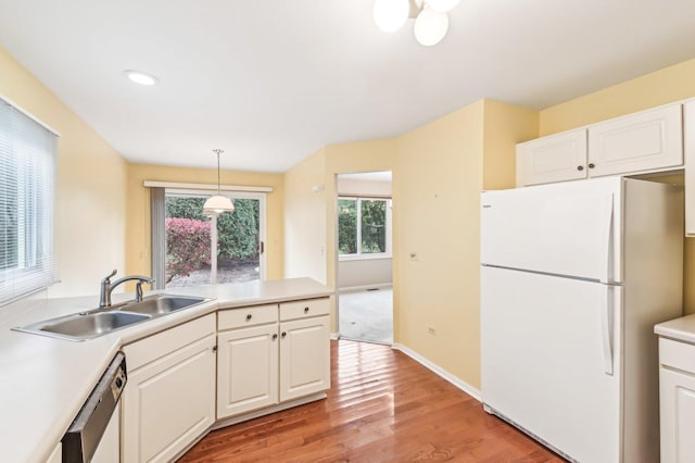 kitchen featuring white cabinetry, white fridge, sink, and stainless steel dishwasher