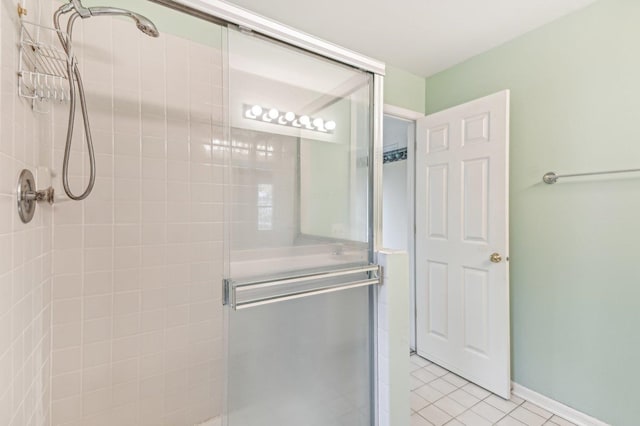 bathroom with tile patterned floors and an enclosed shower