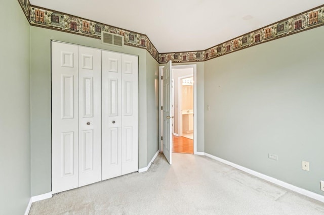 unfurnished bedroom with carpet flooring and a closet