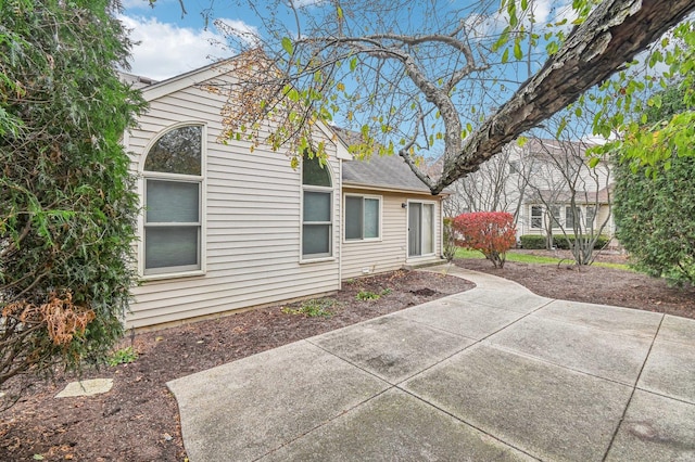 view of side of property featuring a patio area