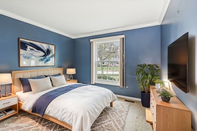 bedroom with crown molding and light hardwood / wood-style flooring