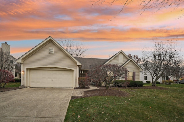 ranch-style house featuring a yard and a garage