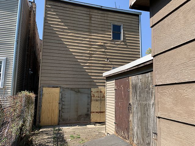 view of side of home with a shed