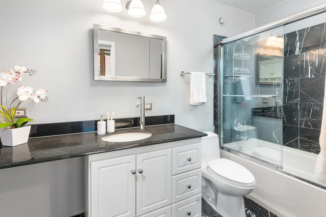 full bathroom with toilet, vanity, and bath / shower combo with glass door