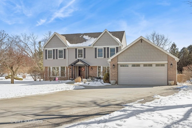 view of front of home with an attached garage, driveway, and brick siding