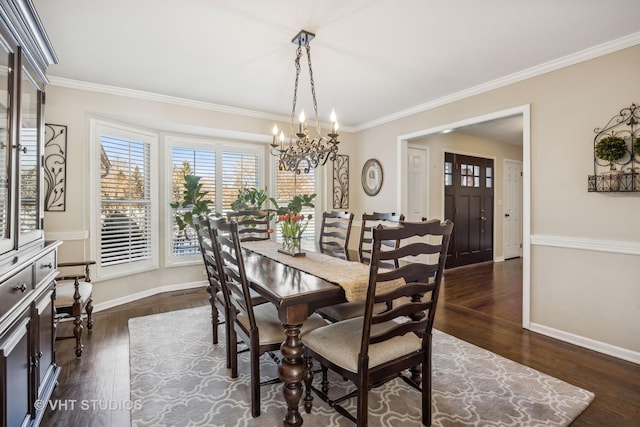 dining room featuring an inviting chandelier, baseboards, dark wood finished floors, and ornamental molding