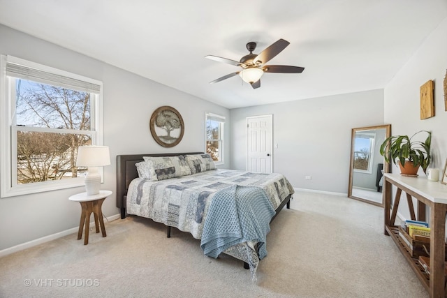 bedroom featuring a closet, light carpet, ceiling fan, and baseboards