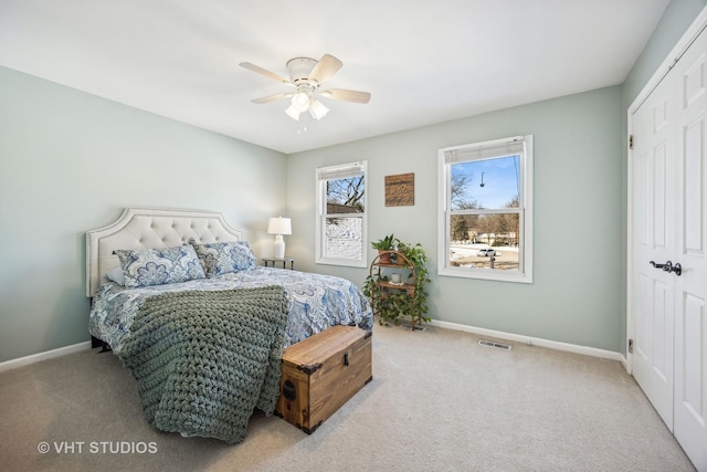 bedroom with carpet floors, visible vents, baseboards, and a ceiling fan