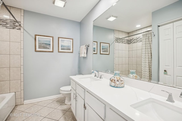 full bath with tiled shower, tile patterned flooring, and a sink