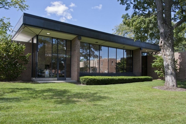 rear view of house with a lawn