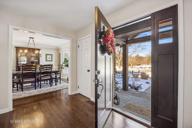 foyer entrance with dark wood-style floors, visible vents, and a wealth of natural light