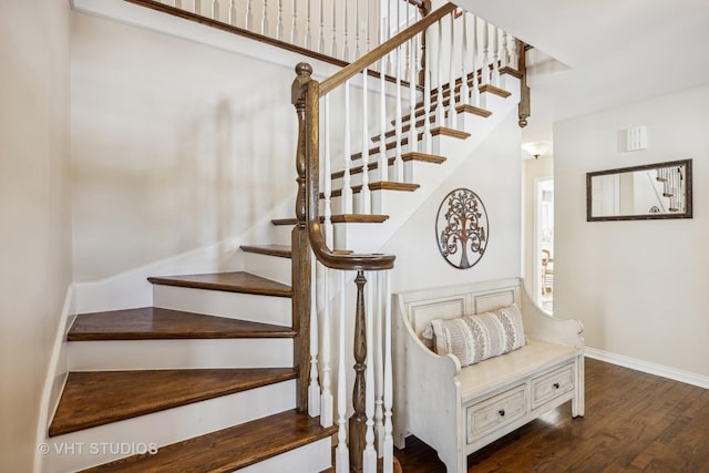 stairs featuring baseboards and wood finished floors