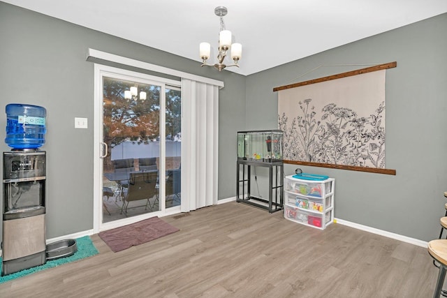 interior space featuring hardwood / wood-style floors and a chandelier