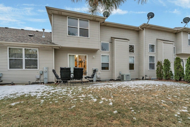 snow covered property featuring central AC