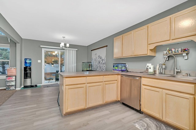 kitchen with stainless steel dishwasher, light brown cabinetry, kitchen peninsula, and sink