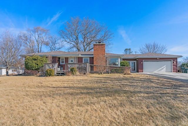 ranch-style home featuring a garage and a front lawn