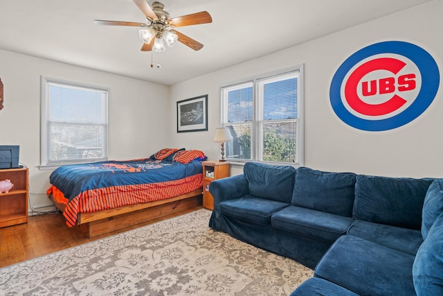 bedroom with ceiling fan and hardwood / wood-style floors