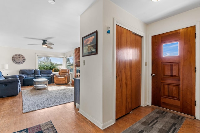 foyer with hardwood / wood-style floors and ceiling fan