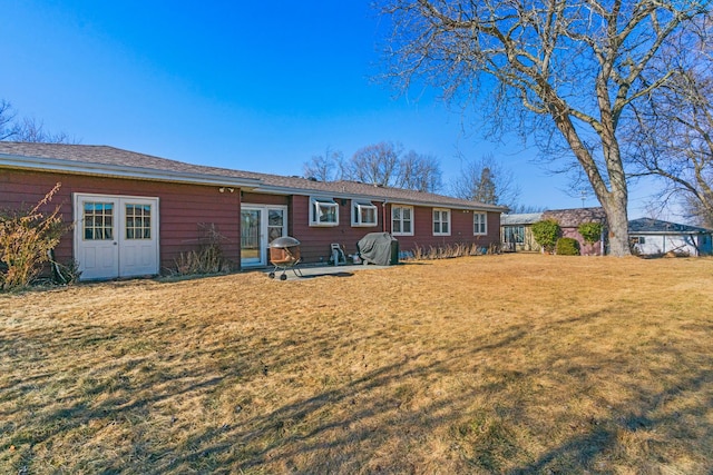 back of property with a lawn