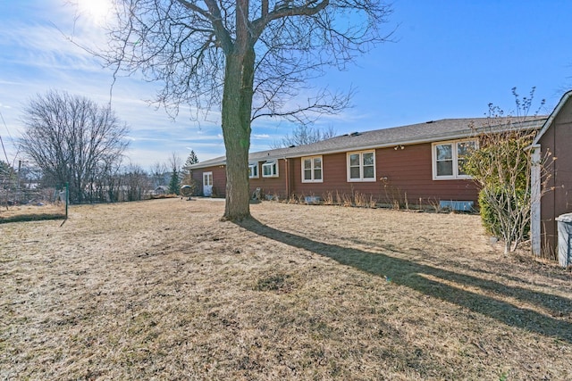 rear view of house featuring a yard