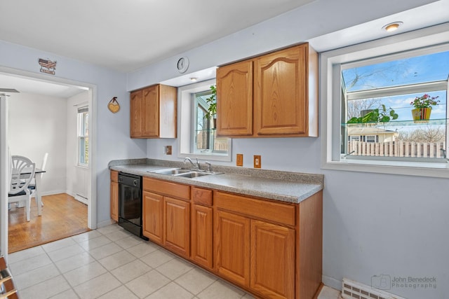 kitchen with light tile patterned flooring, dishwasher, sink, and a baseboard heating unit