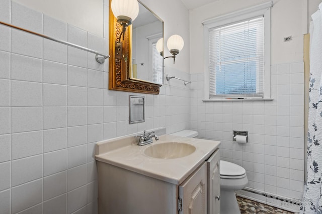 bathroom with vanity, a baseboard radiator, toilet, and tile walls