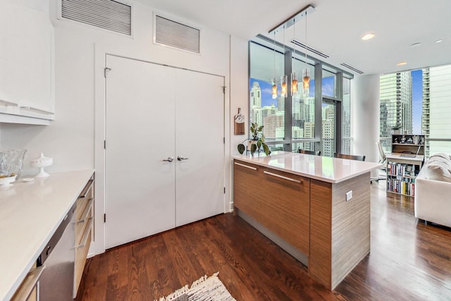 kitchen featuring dishwasher, white cabinets, a wall of windows, kitchen peninsula, and dark wood-type flooring