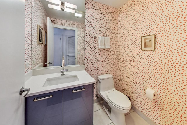 bathroom featuring tile patterned flooring, vanity, and toilet