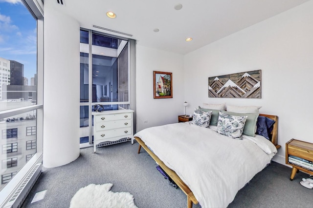 bedroom featuring floor to ceiling windows and carpet floors