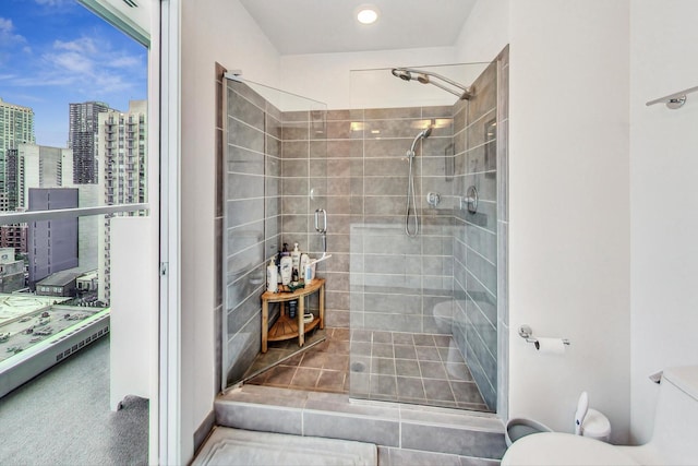 bathroom featuring walk in shower and toilet