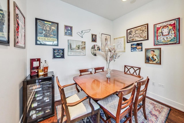 dining area featuring wine cooler and hardwood / wood-style flooring