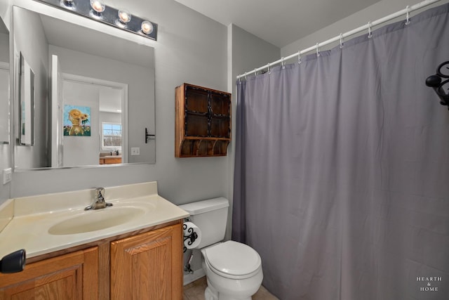 bathroom featuring vanity, toilet, and a shower with shower curtain