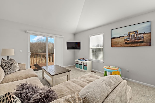 carpeted living room featuring lofted ceiling