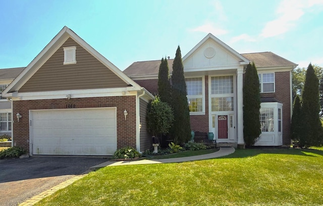 view of front of property with a garage and a front lawn