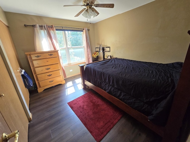 bedroom with dark hardwood / wood-style flooring and ceiling fan