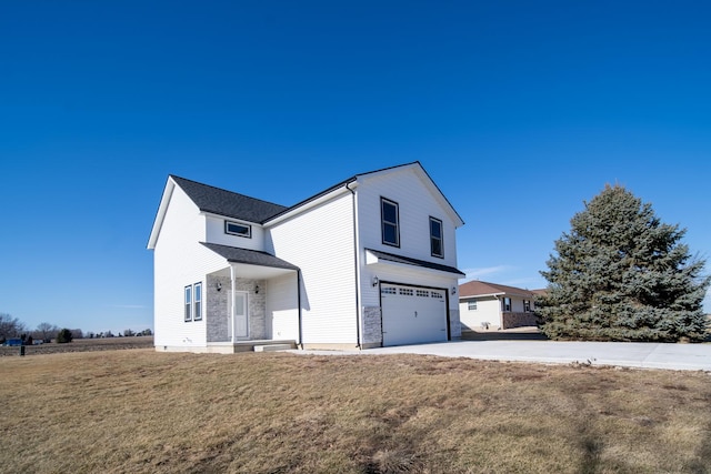 view of front of home with a garage and a front lawn