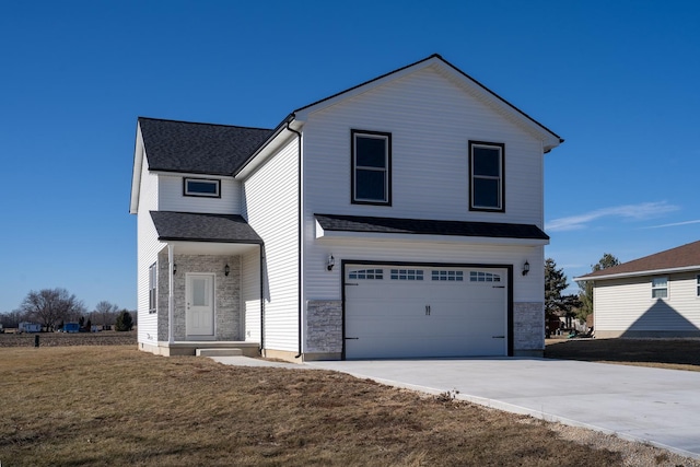 view of front facade with a garage and a front lawn