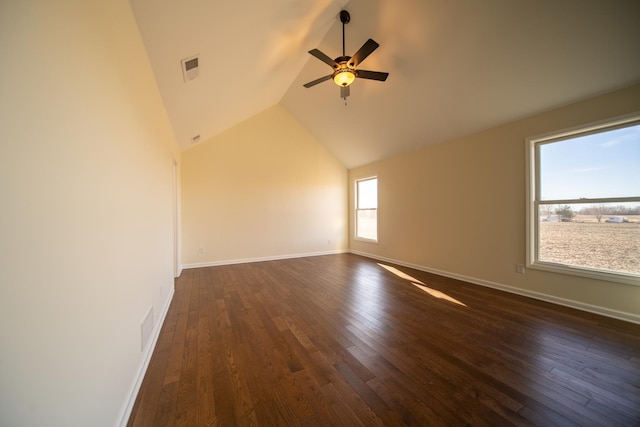 spare room with ceiling fan, dark hardwood / wood-style floors, and vaulted ceiling