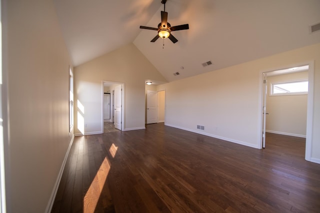 unfurnished living room with high vaulted ceiling, dark hardwood / wood-style floors, and ceiling fan