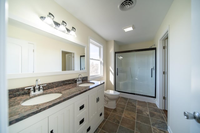 bathroom featuring walk in shower, vanity, and toilet