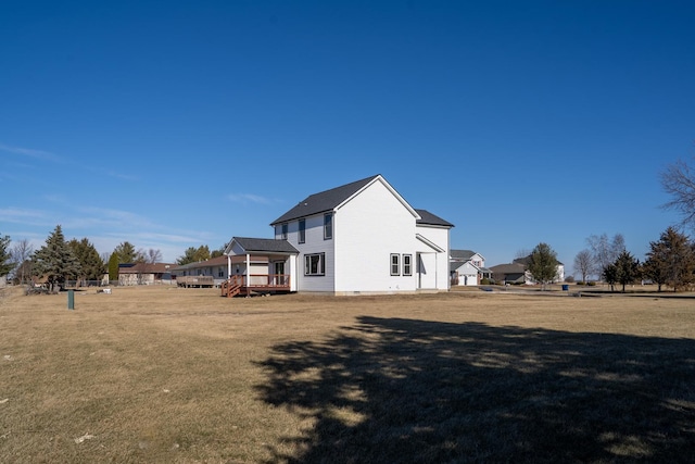 back of house featuring a lawn