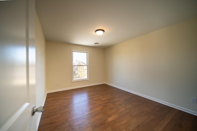 empty room featuring dark hardwood / wood-style floors