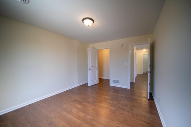 unfurnished bedroom with dark wood-type flooring